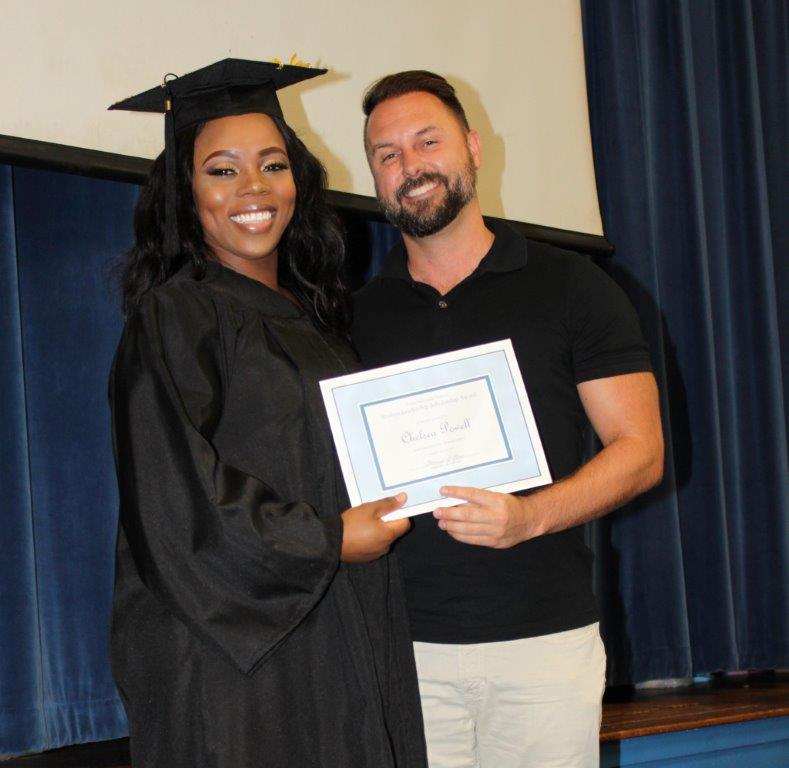 Chad Newberry presents Chelsea Powell with a $1000 scholarship provided by the DBBAR Young Professionals Network