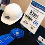 Newberry construction hat on table with Outstanding Feature Award blue ribbon