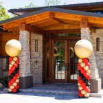 main entrance of Japandi house with balloon pillars set before stone columns