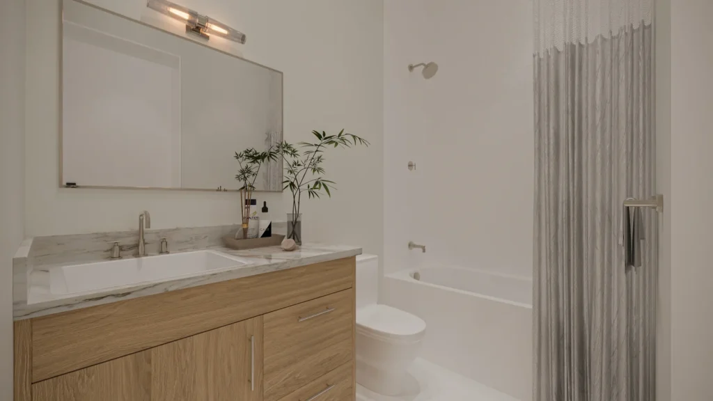 Carrie model guest bathroom with a wood vanity, marble counter, and shower-tub combo at Six in the City, College Park Orlando