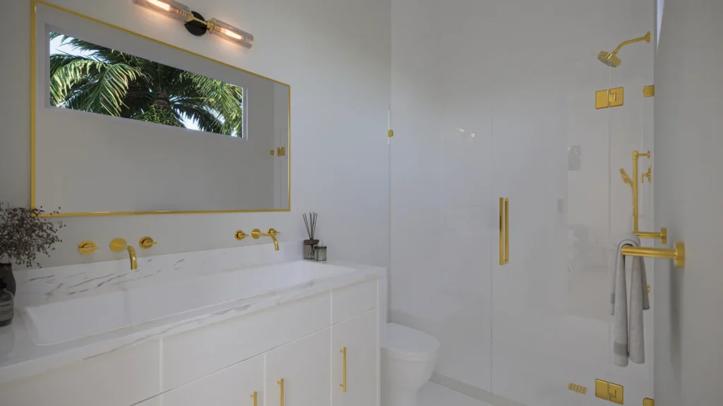 Carrie model primary bathroom with marble vanity, gold fixtures, and glass walk-in shower at Six in the City, College Park Orlando
