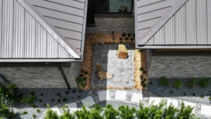 japandi zen courtyard with gravel, stone walls, and wood detailing