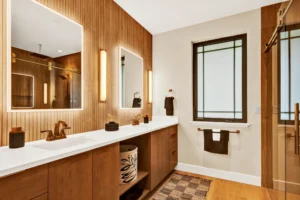 japandi bathroom with frameless cabinetry, wood finishes, and modern fixtures
