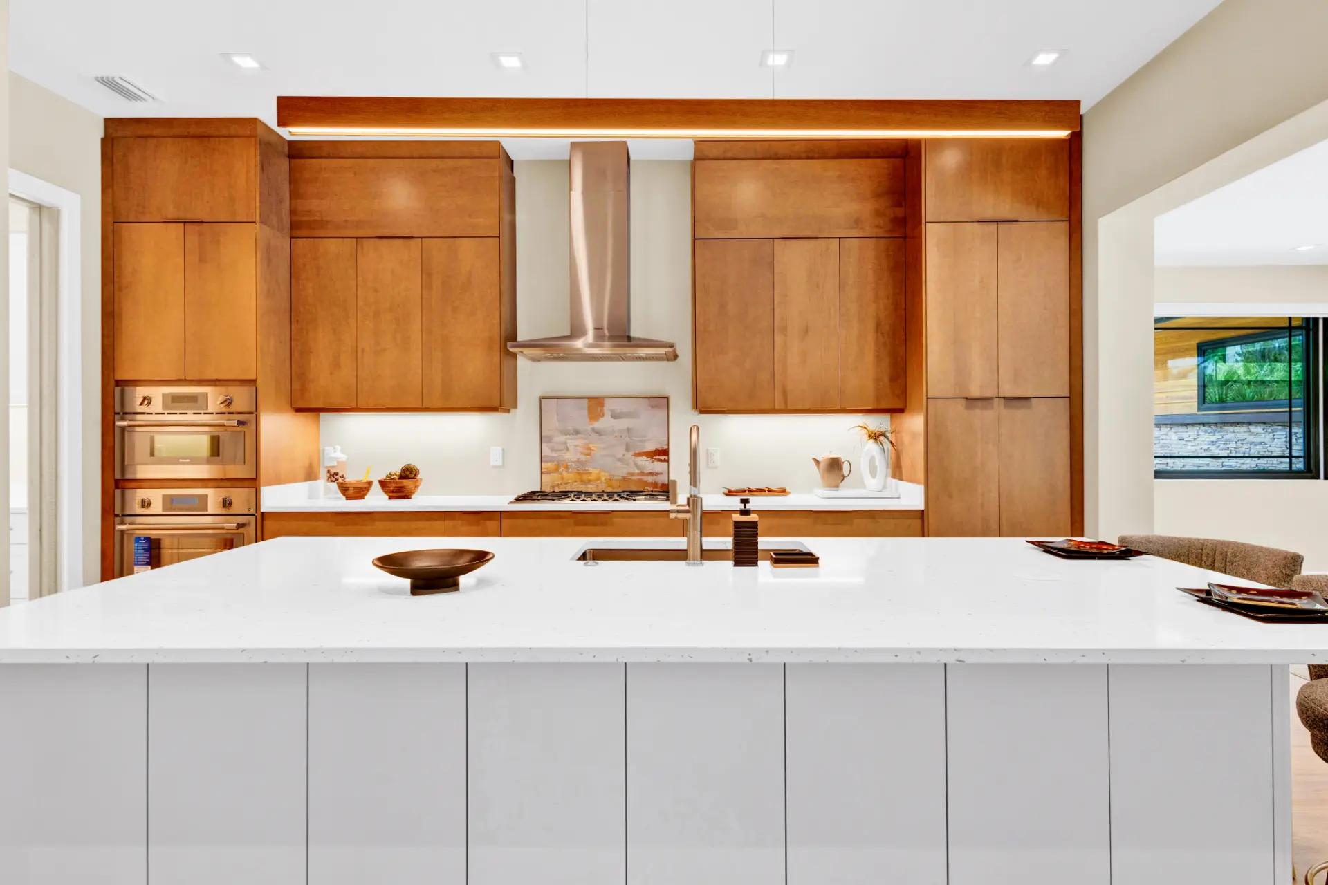 custom kitchen cabinetry with built in wall ovens and modern wood finish