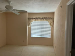 Before bedroom remodel showing outdated finishes and layout prior to renovation south of Daytona Beach.