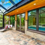 screened pool lanai with cypress ceiling and stone columns
