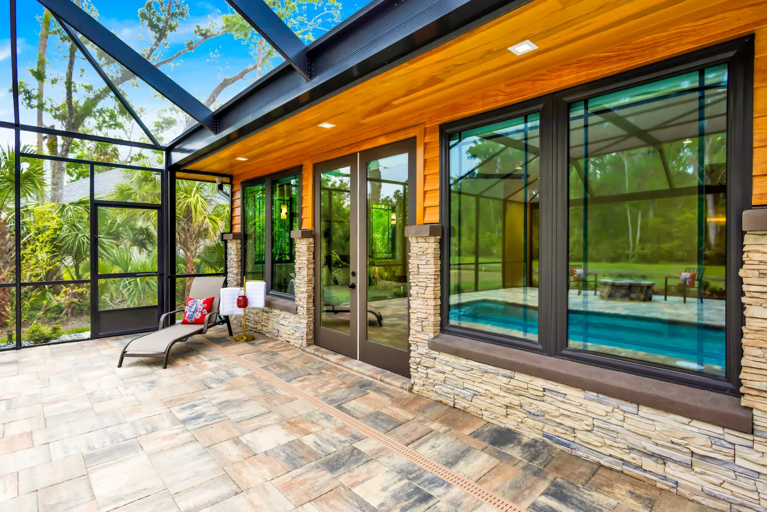 screened pool lanai with cypress ceiling and stone columns