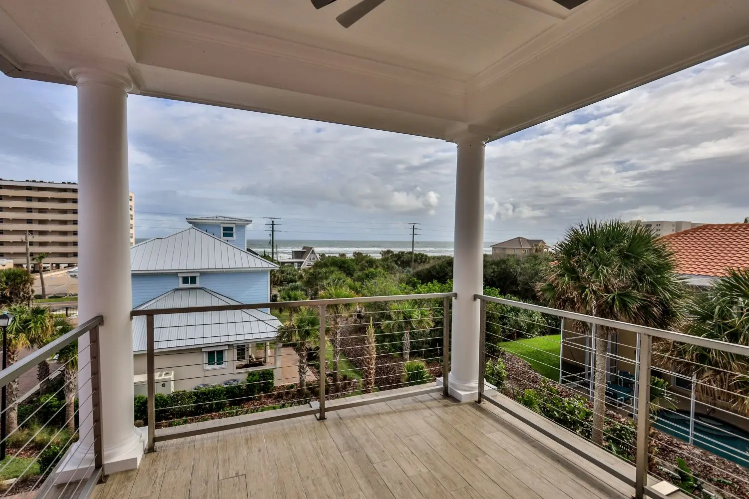 Covered oceanfront balcony of The Mallory custom home by Newberry Homes overlooking the Atlantic in Ponce Inlet, Volusia County, FL